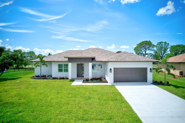 view of front facade with a garage and a front lawn