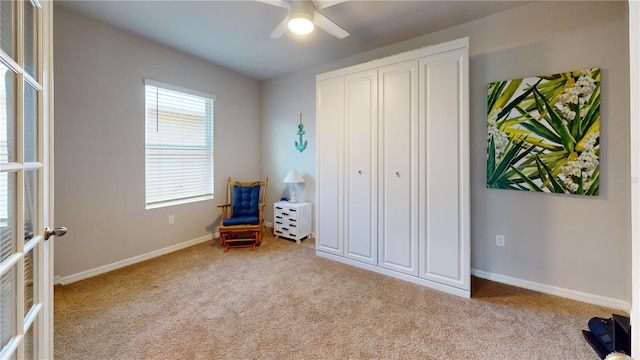 unfurnished room featuring carpet, a ceiling fan, and baseboards