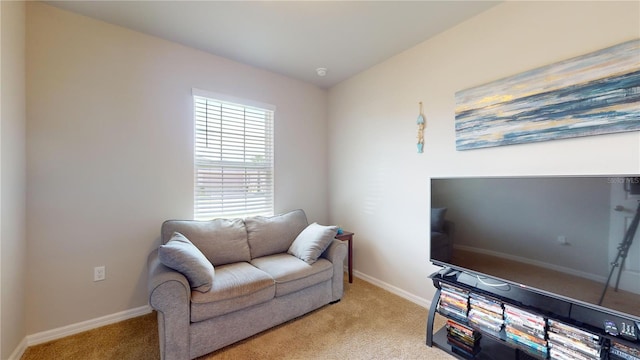 sitting room featuring light colored carpet