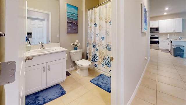 bathroom with tile patterned floors, vanity, and toilet