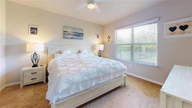 carpeted bedroom featuring baseboards and a ceiling fan