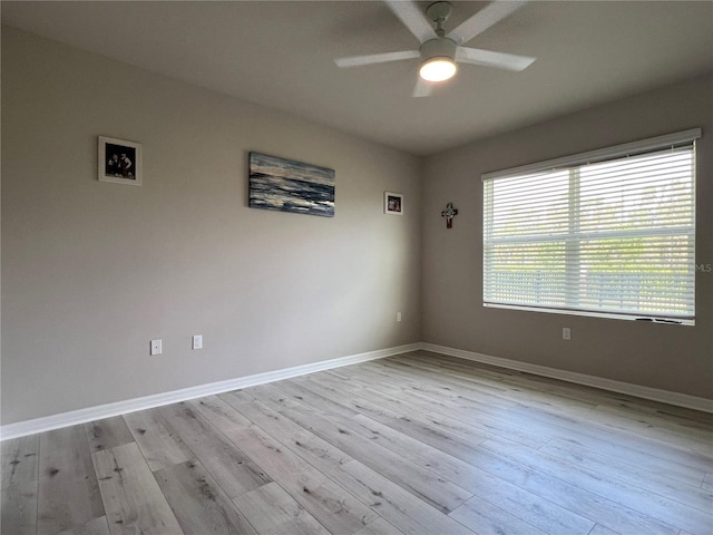 unfurnished room with a ceiling fan, baseboards, and light wood finished floors