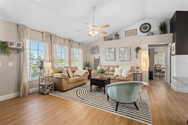 living room with light wood-type flooring, ceiling fan, and high vaulted ceiling