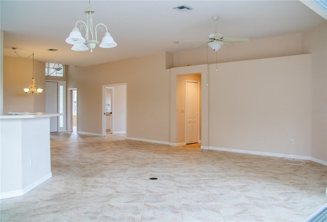 empty room featuring ceiling fan with notable chandelier