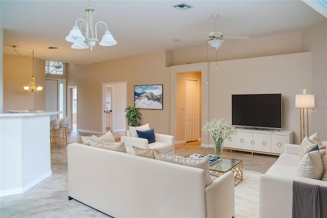 living room with ceiling fan with notable chandelier