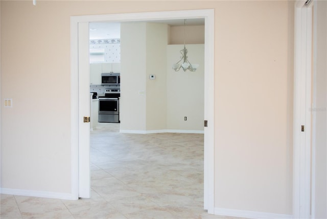 hallway with a chandelier