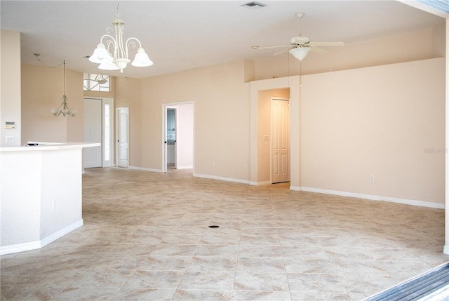 empty room featuring ceiling fan with notable chandelier