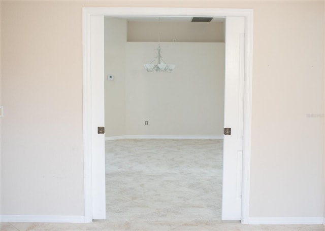 spare room featuring a chandelier