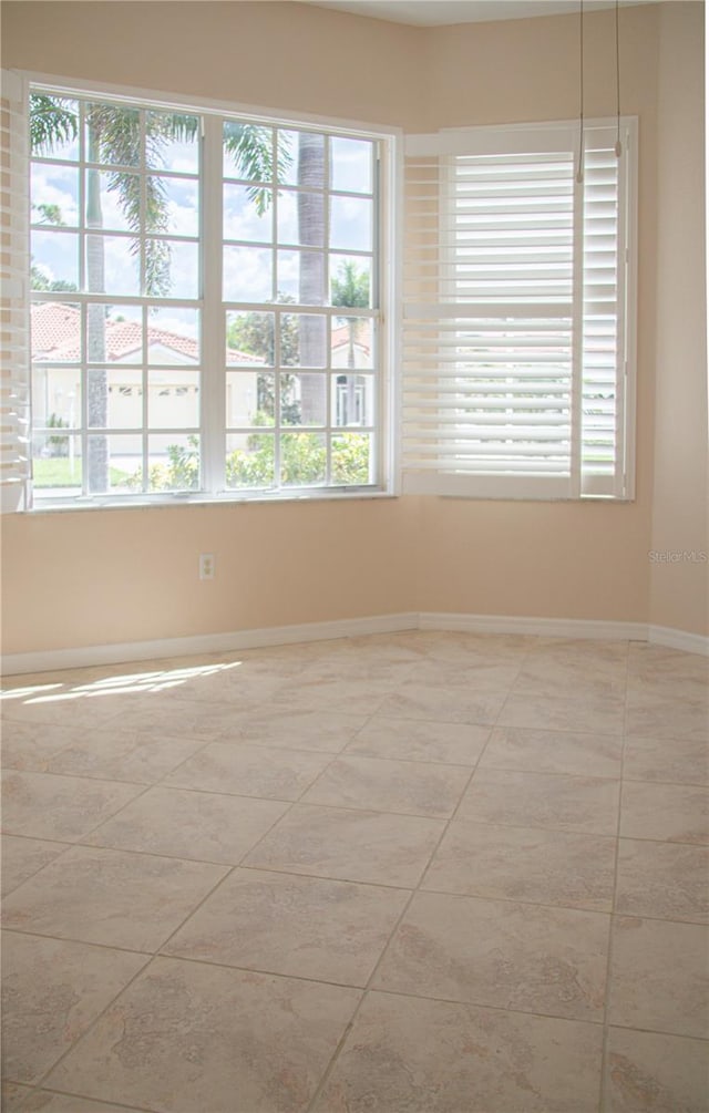 tiled empty room with plenty of natural light