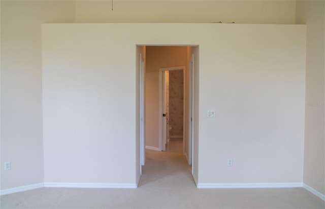 unfurnished room with light carpet