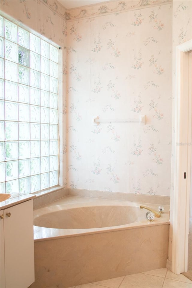 bathroom featuring tile patterned floors, plenty of natural light, and a bathtub