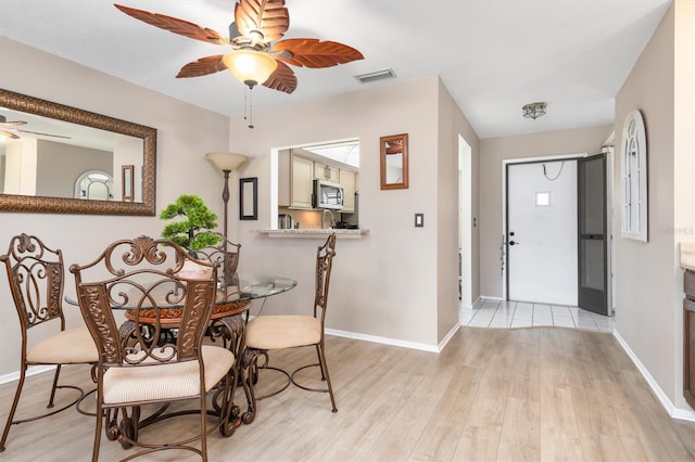 dining area featuring ceiling fan and light hardwood / wood-style floors