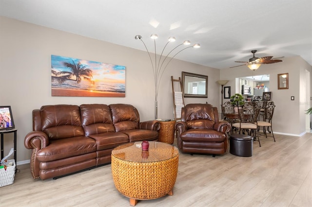 living room featuring ceiling fan and light wood-type flooring