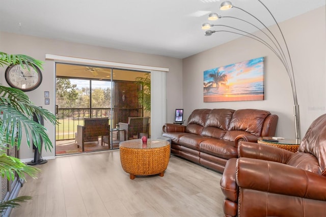 living room featuring light wood-type flooring and ceiling fan