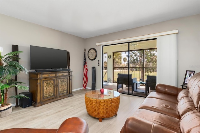 living room featuring ceiling fan and light hardwood / wood-style floors