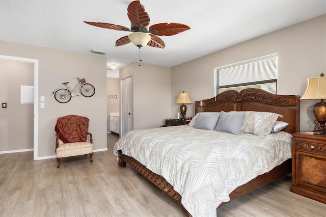 bedroom featuring connected bathroom, ceiling fan, a closet, and light hardwood / wood-style floors