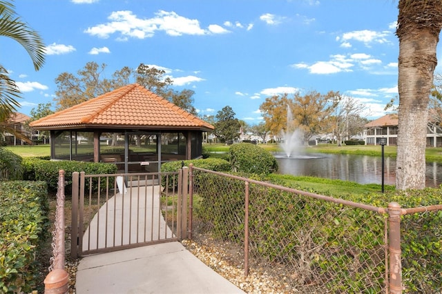 surrounding community featuring a gazebo and a water view