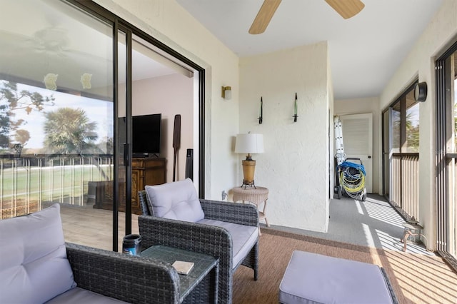 sunroom / solarium featuring ceiling fan