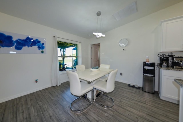 dining area with dark wood-type flooring