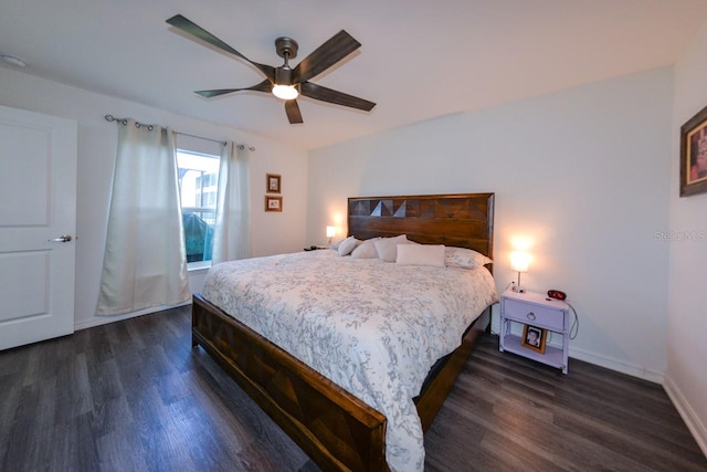 bedroom with ceiling fan and dark hardwood / wood-style floors