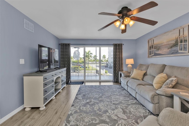 living room featuring ceiling fan and light wood-type flooring