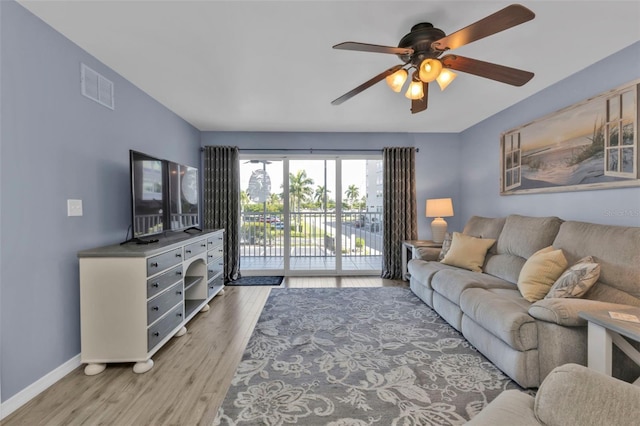 living area with a ceiling fan, baseboards, light wood-style flooring, and visible vents