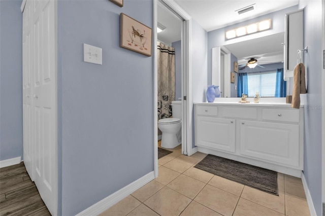 bathroom featuring tile patterned flooring, ceiling fan, vanity, and toilet