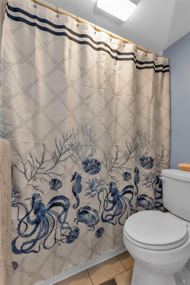 bathroom with tile patterned floors and toilet