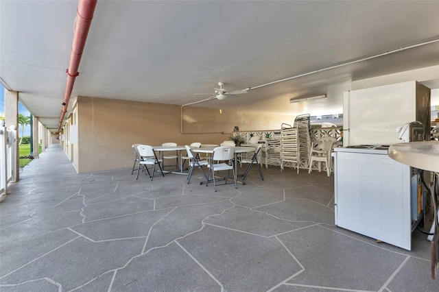 view of patio with outdoor dining area and ceiling fan