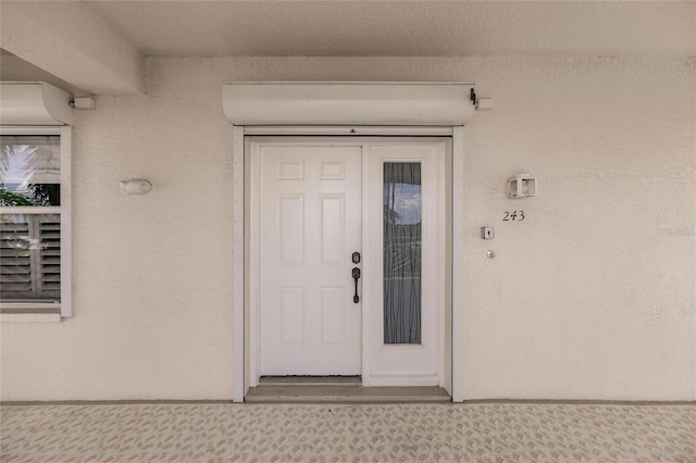 doorway to property with stucco siding