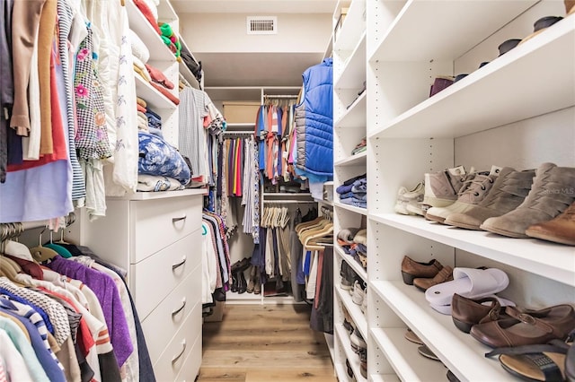 spacious closet with light wood finished floors and visible vents