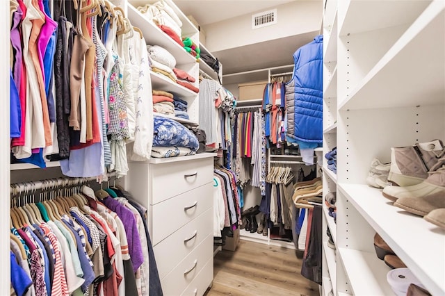 walk in closet with visible vents and wood finished floors