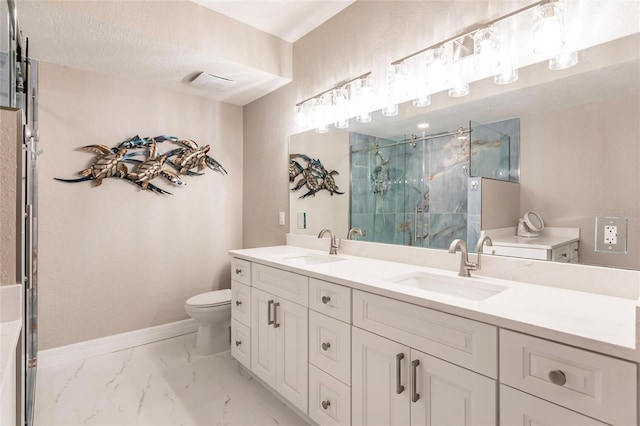 bathroom with a textured ceiling, a shower with door, vanity, and toilet