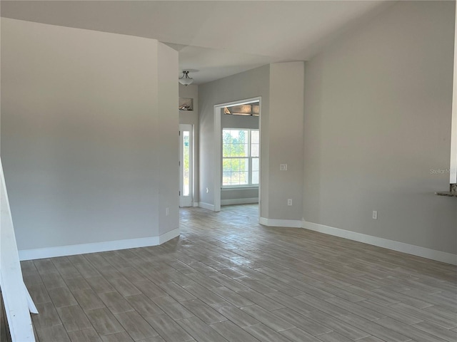 spare room with light wood-style flooring and baseboards