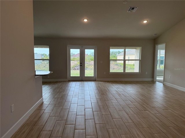 unfurnished room featuring baseboards, wood tiled floor, visible vents, and recessed lighting