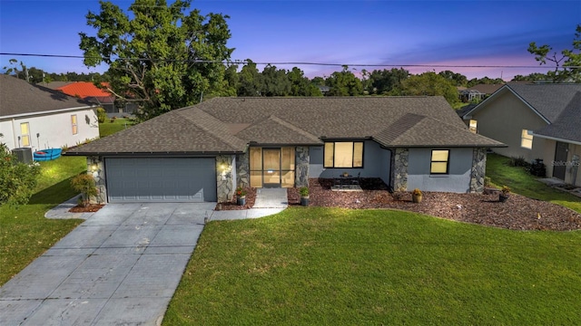 single story home with a yard and a garage