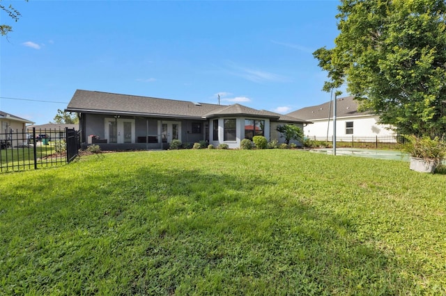 view of front of home with a front yard and a sunroom