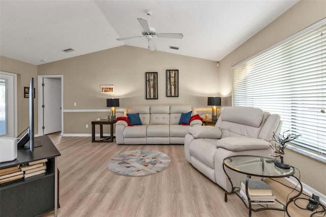 living room with light hardwood / wood-style floors, plenty of natural light, lofted ceiling, and ceiling fan