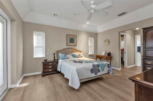 bedroom featuring a closet, light hardwood / wood-style floors, a spacious closet, and ceiling fan