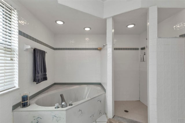 bathroom featuring separate shower and tub