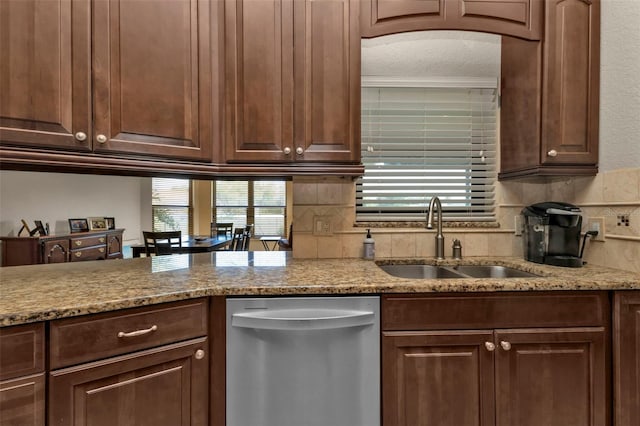 kitchen with decorative backsplash, light stone countertops, stainless steel dishwasher, dark brown cabinets, and sink