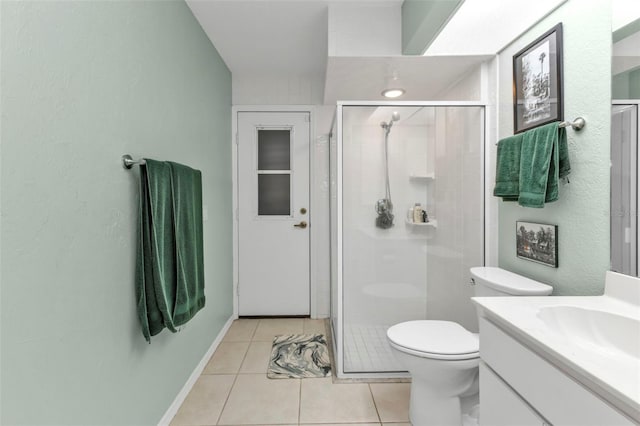 bathroom featuring tile patterned flooring, vanity, toilet, and a shower with shower door