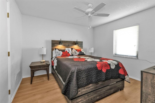 bedroom featuring ceiling fan and light hardwood / wood-style flooring