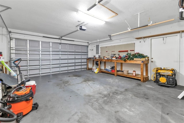 garage featuring a workshop area, a garage door opener, and electric panel