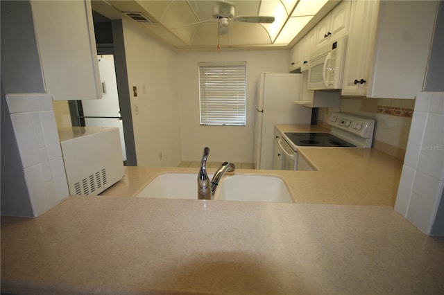 kitchen with tasteful backsplash, white cabinets, white appliances, ceiling fan, and sink