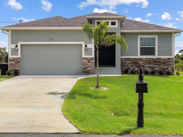 view of front facade with a garage and a front lawn