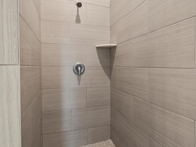 bathroom with a tile shower