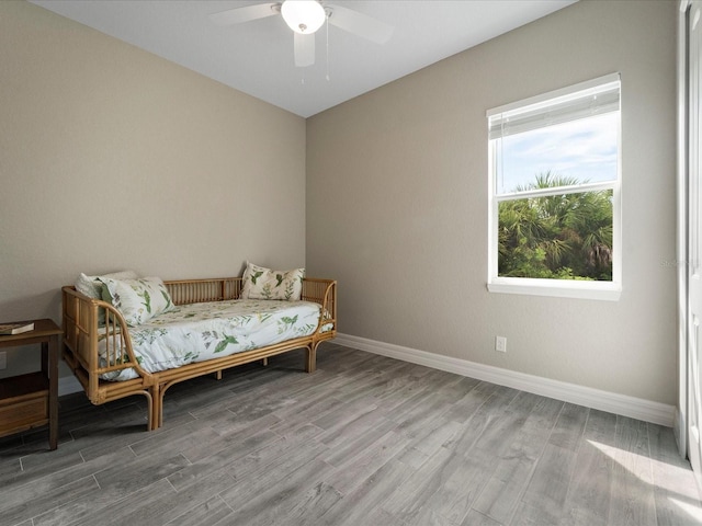 sitting room with ceiling fan and hardwood / wood-style floors