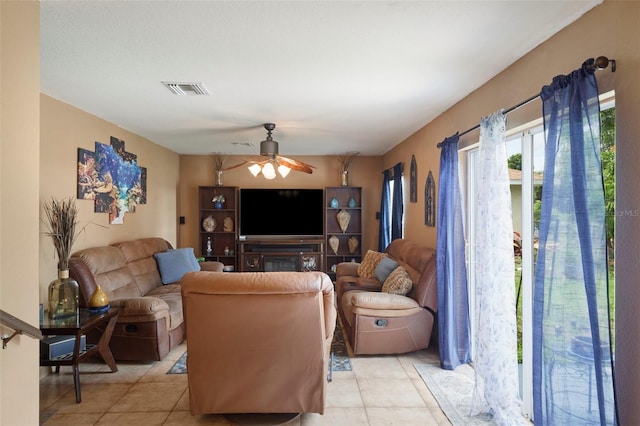 living room featuring ceiling fan and light tile patterned floors