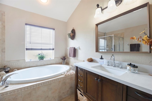 bathroom featuring shower with separate bathtub, lofted ceiling, and vanity